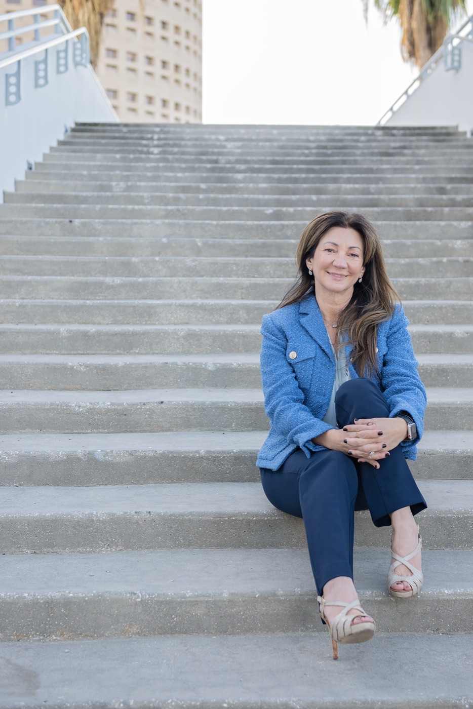 Carrie sitting on wide stone steps, smiling