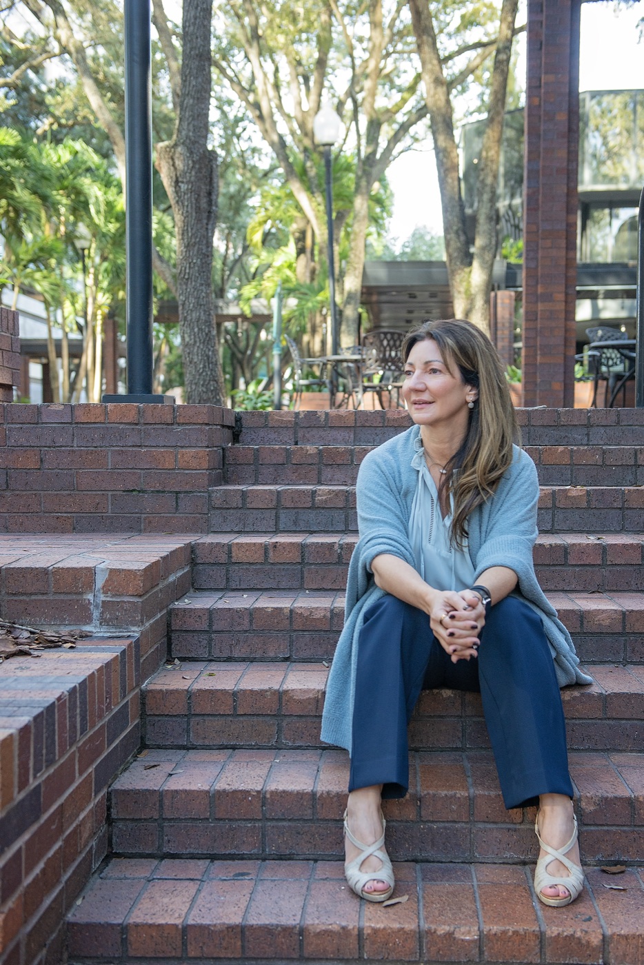 Carrie sitting on brick steps, smiling
