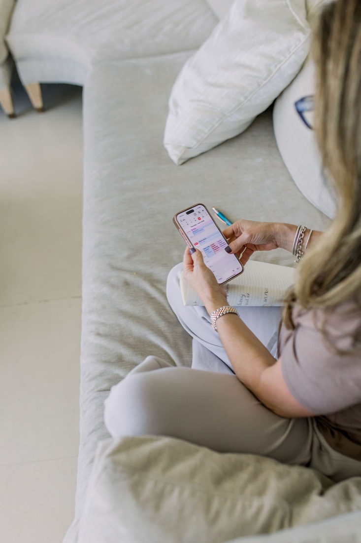 Carrie on the sofa looking at her phone