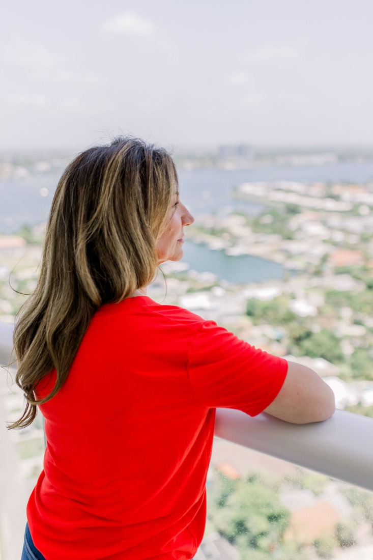 Carrie looking out over the water from her balcony